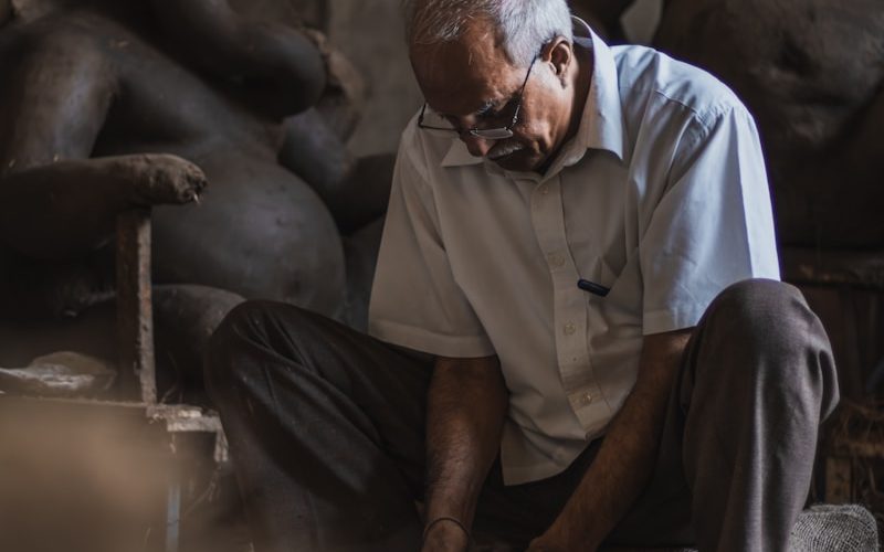 a man is working on a sculpture in a workshop