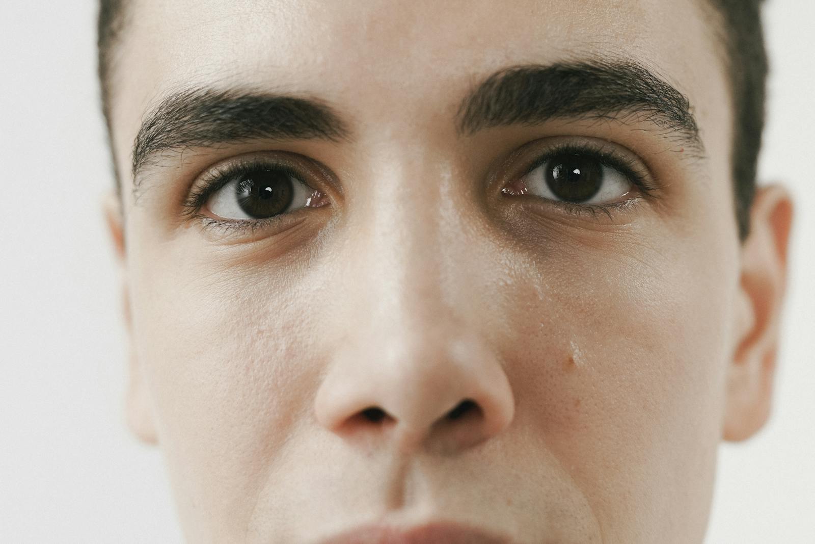 Close-up shot highlighting a young man's facial features and clear expression.