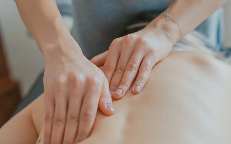 man massaging woman's body