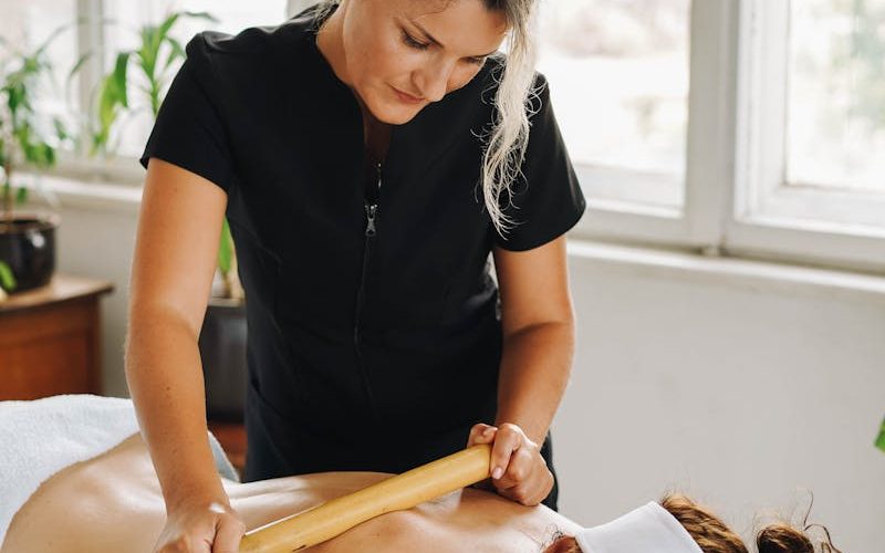 Woman receiving a relaxing bamboo massage at a wellness spa.